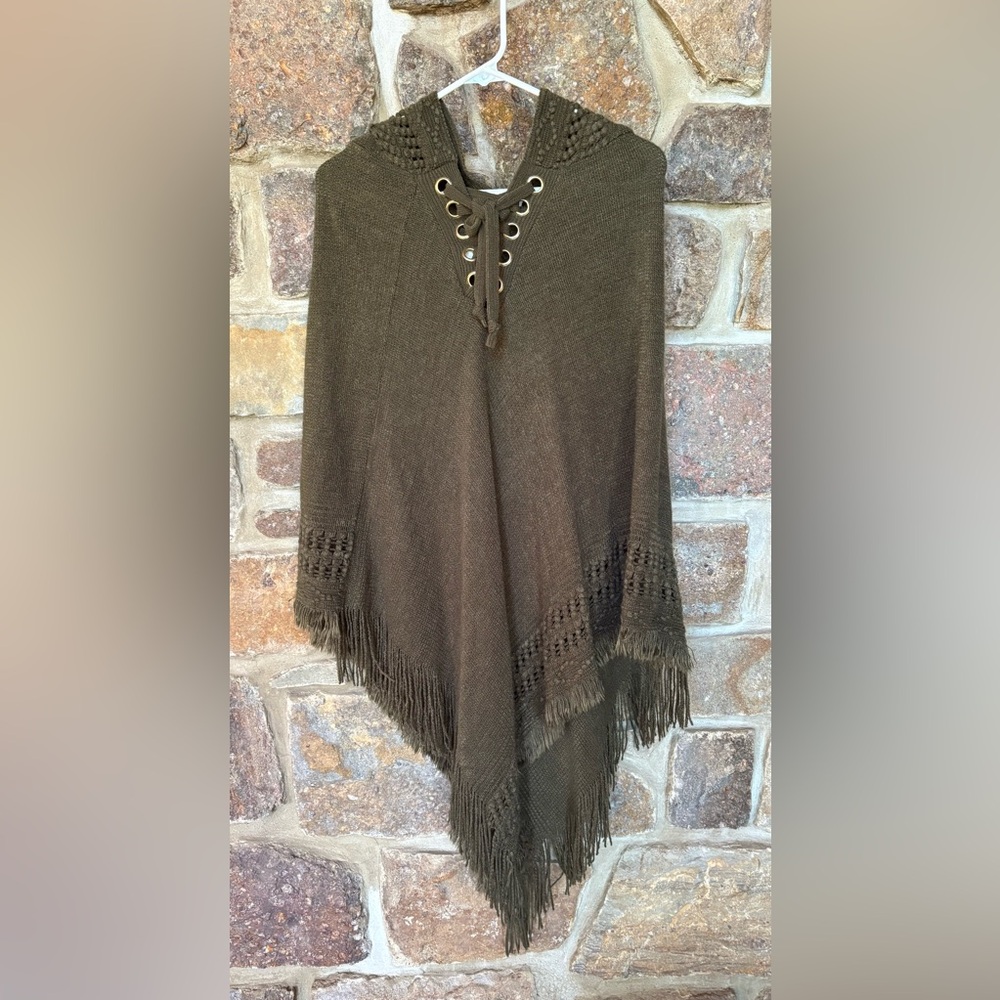 TASSLED PONCHO. 100% Acrylic. Tie front. No brand listed.